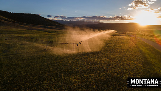 watering glow pivot in hayfield glowing during the montana sunset thumbnail